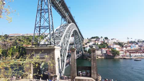 the view over porto's douro river with boats, rooftops, and the luis i bridge under a bright sky