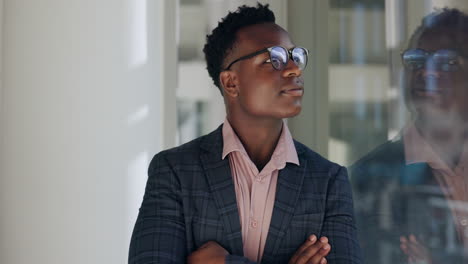 young professional looking out a window