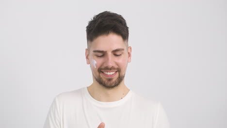 Attractive-Man-Applying-Moisturizer-To-His-Forehead