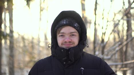 man in winter clothing in snowy forest