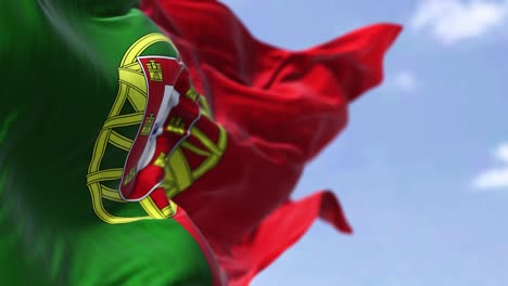 detail of the national flag of portugal waving in the wind on a clear day