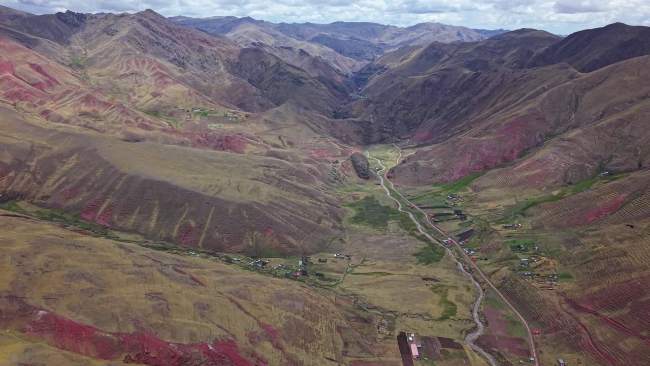 Vibrant aerial view of Rainbow Mountain and Red Valley, Peru's natural wonders