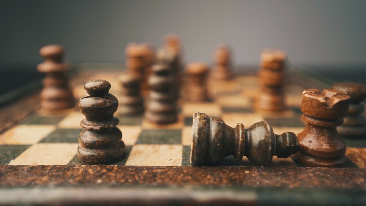 Checkmate chess king falling in slow motion