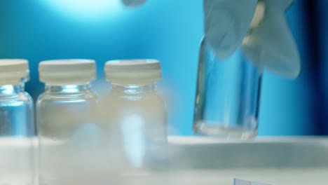 a medical professional places vials of vaccine on a hospital tray for use - concept: business, opening, travel, hotel, hope, normal life