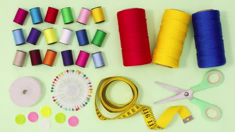 creative layout made of moving sewing and knitting items on green theme. stop motion