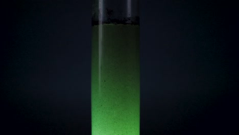 alien tube with green liquid spaceship fuel in slow motion