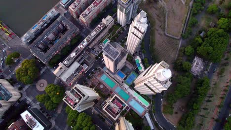 overhead aerial view of luxury high-rise apartments with swimming pool at blue hour, puerto madero, buenos aires