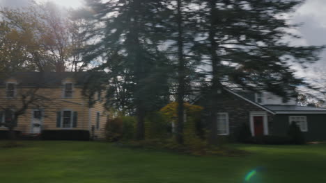 Drive along a residential area in a typical suburb of the United States. The sun is shining from behind the houses