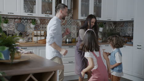 family dancing in kitchen