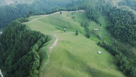 aerial-view-of-grassland-middle-of-forest-in-Kulekhani,-Nepal