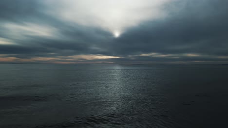 aerial view of dark cloudy day at sea moving backwards