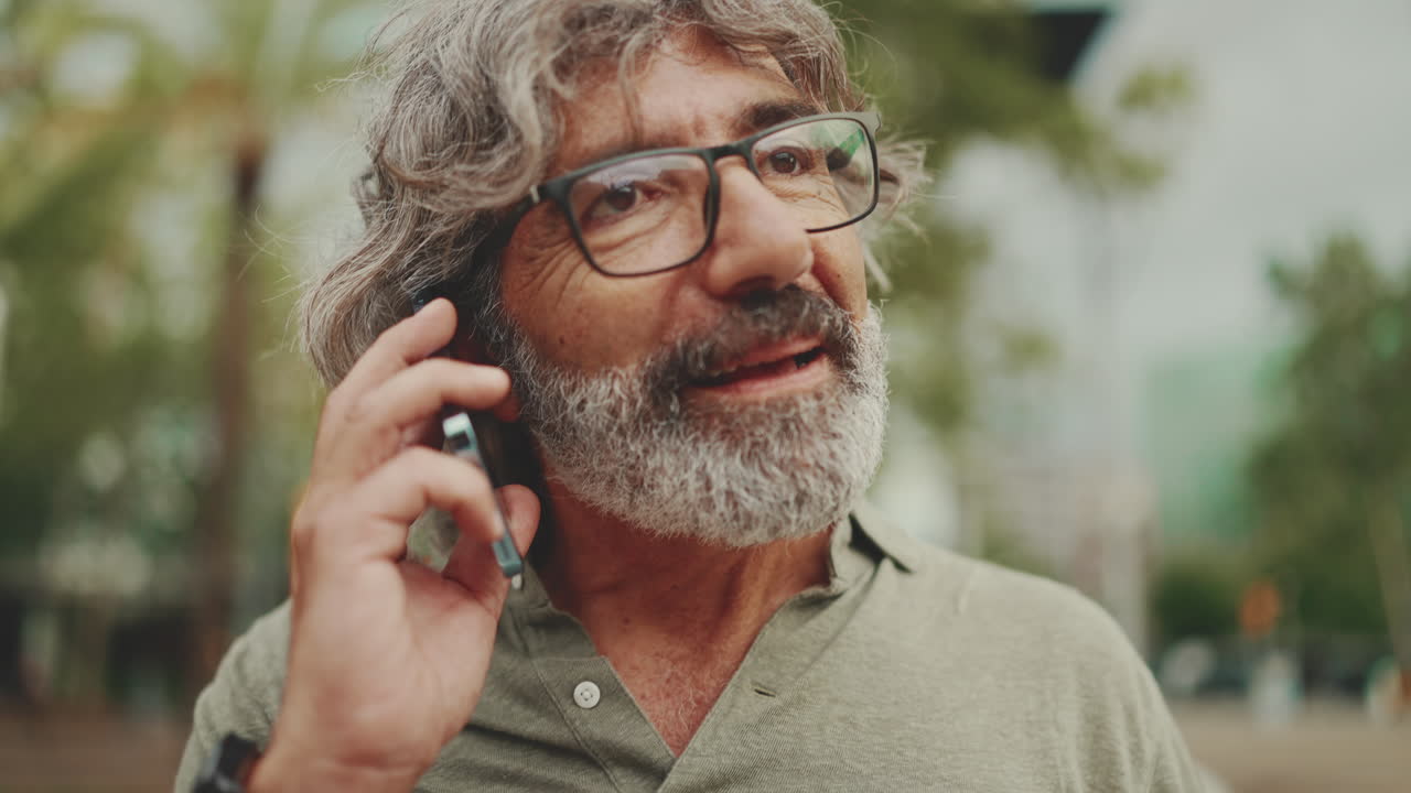 Man talking on phone outdoors