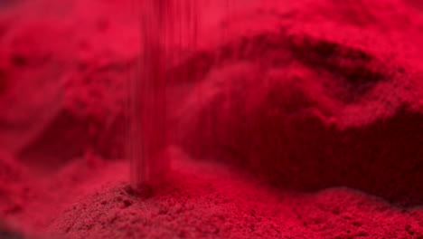 red sand dropping on ground