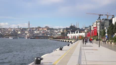 people walking along the waterfront in istanbul, turkey