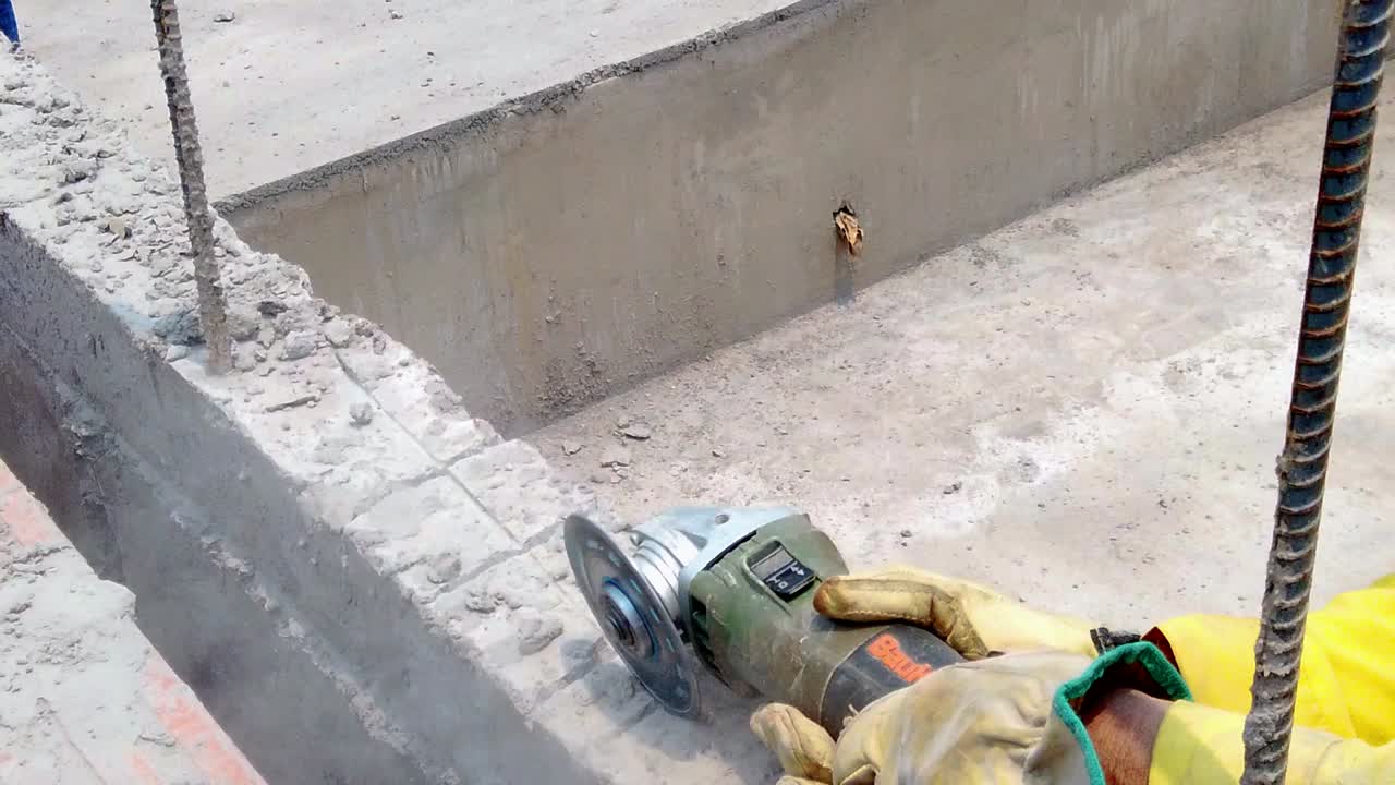 Worker cutting stone, grinding machine in slow motion.
