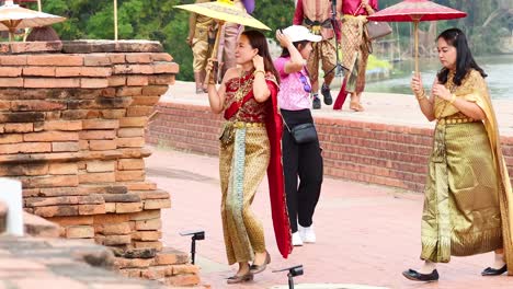 tourists exploring ayutthaya in traditional thai attire