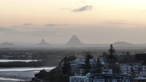 telephoto drone view glasshouse mountains on hazy sunset horizon, 4k sunshine coast australia