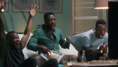 friends watching tv and celebrating