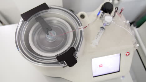 blood moves by the tube in the centrifuge machine. device preparing concentrate for prp therapy. close up.