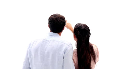 attractive young couple pointing and smiling at camera