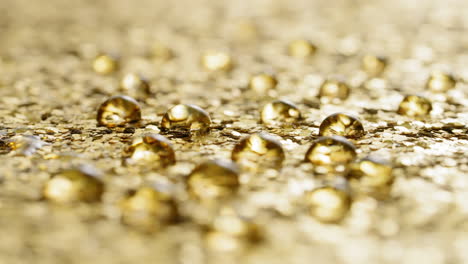 water drops on golden sparkly background, static