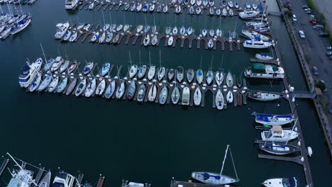 a very large dock with a marina and sail boats in slips