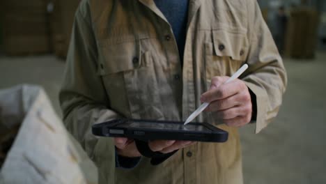 warehouse worker using tablet for inventory