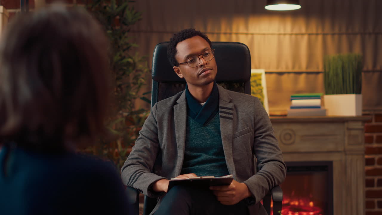 African american counselor listening to couple at therapy session