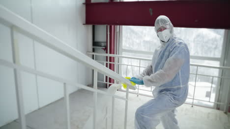 cleaning stair railing with ppe