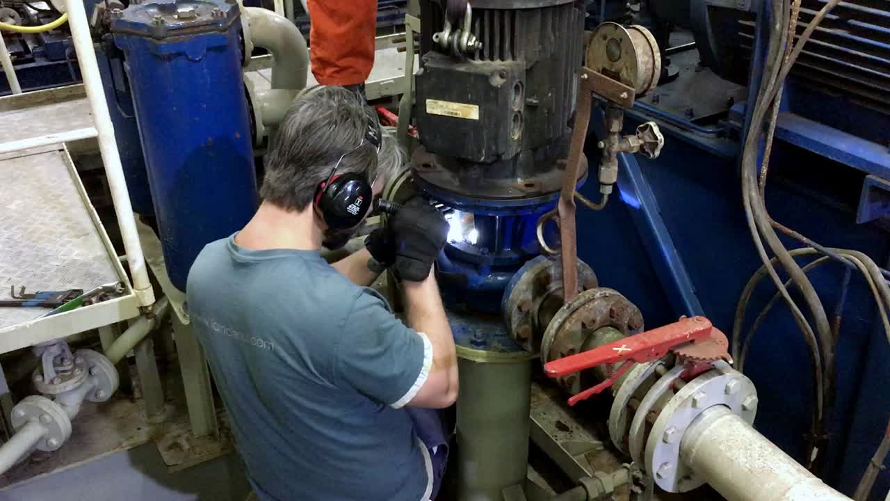 Male repairman working on the valves of a ship with protection on