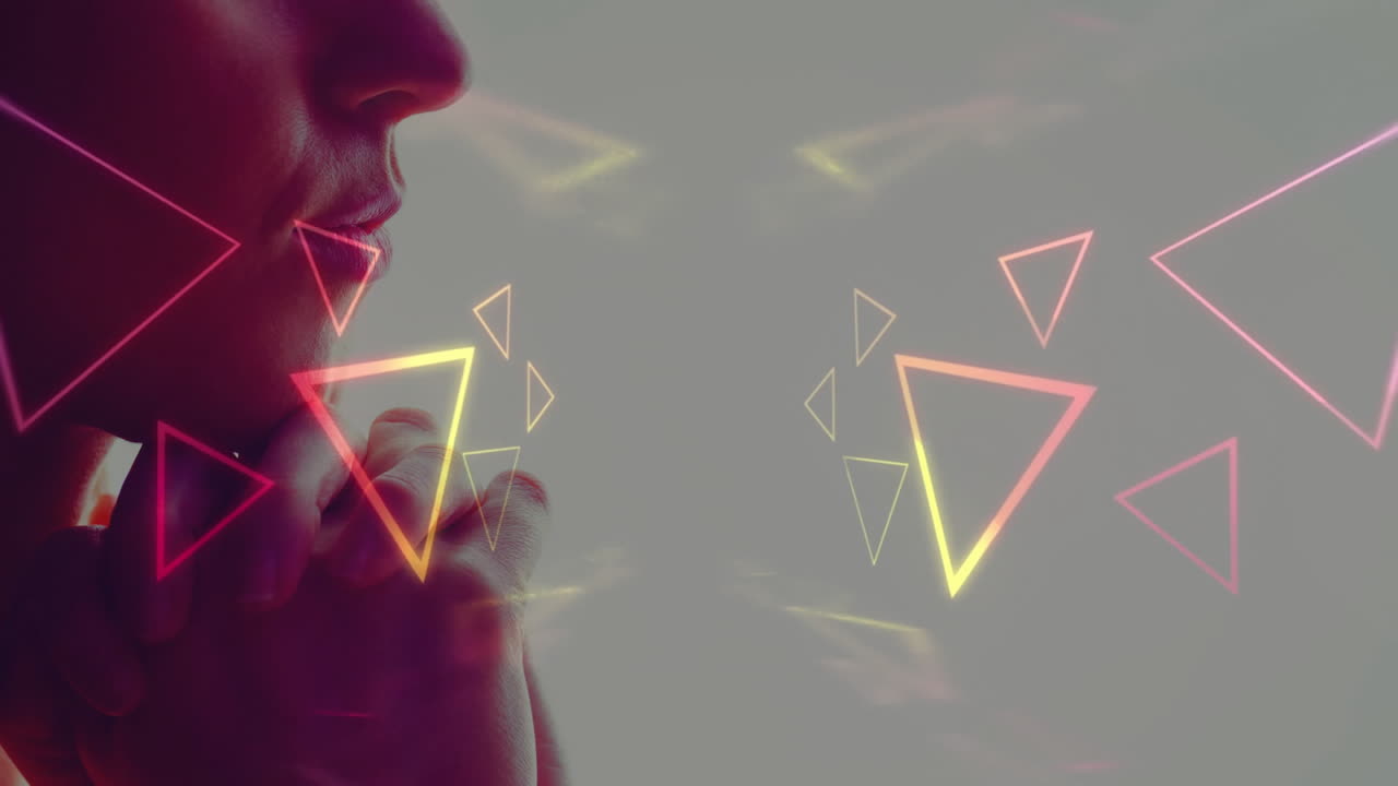 Neon triangles animation over thoughtful person with hand on chin