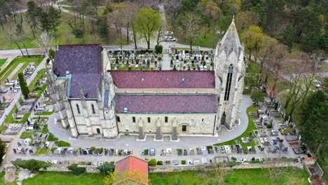 gothic catholic church surrounded by gravestones in bad deutsch-altenburg, lower austria