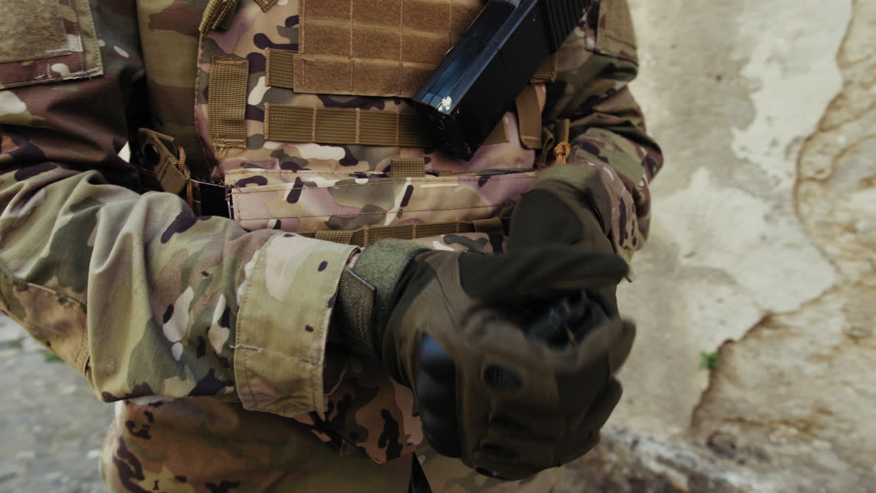 Soldier Closes And Places His Compass In The Pouch