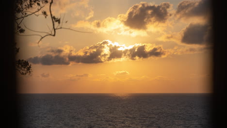 static view of the rising sun over the adriatic sea through the clouds in montenegro in timelapse.
