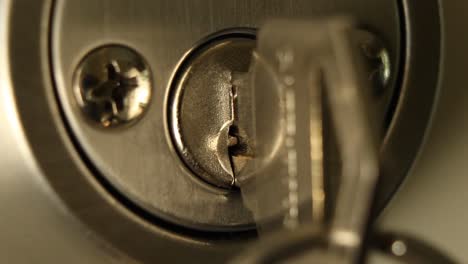 key inserted into deadbolt door lock and removed residential close up