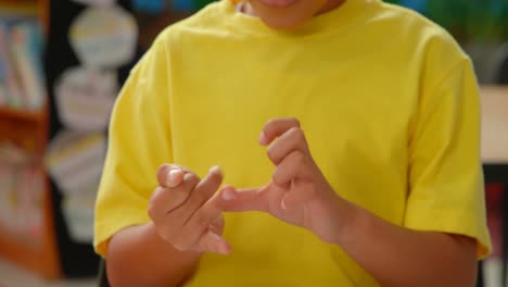 front view of african american schoolboy counting with his finger at desk in a classroom at school 4