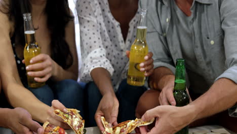 amigos felices compartiendo una pizza
