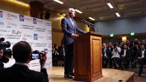 politician or speaker addressing an audience at a press conference or campaign event