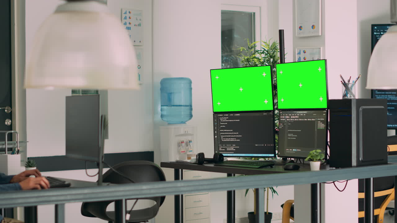 Asian system engineer using html script code and greenscreen on multiple monitors