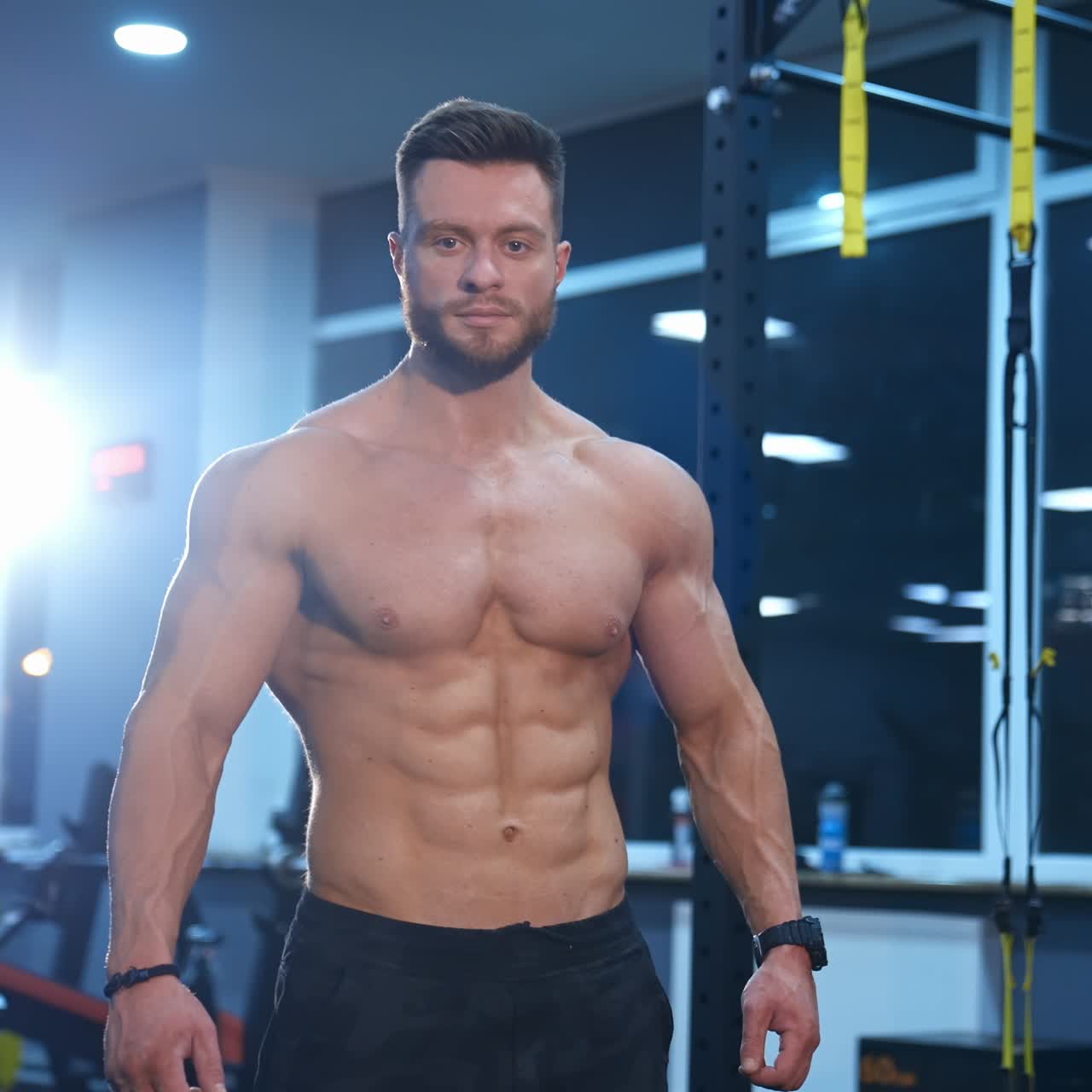 Muscular man posing in gym