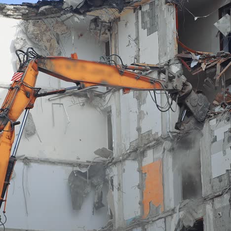 special machine destroys the house. demolition excavator destroys an old building