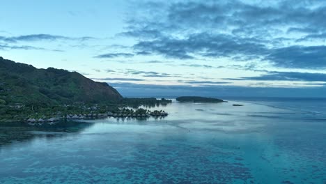 island of moorea at sunset on pacific ocean, french polynesia. drone shot, hyperlapse