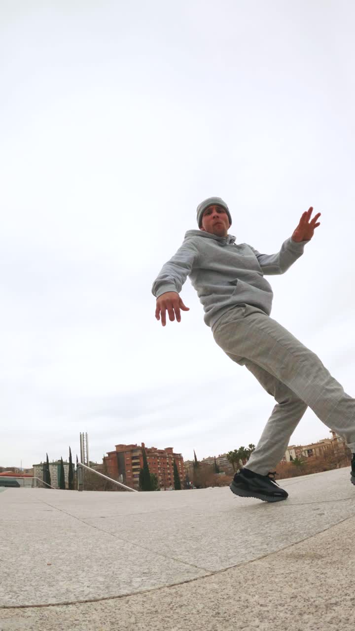 Energetic dancer performing street dance moves in urban setting