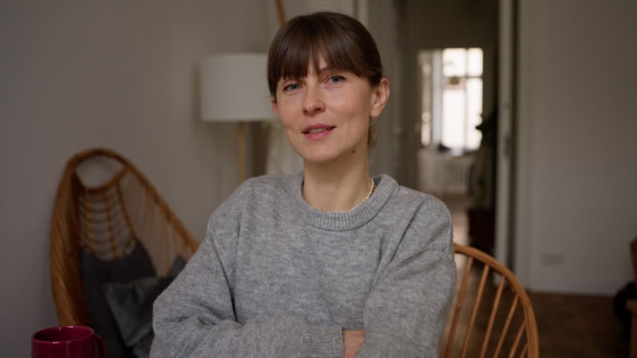 Woman Sitting at Home, Working or Having Breakfast