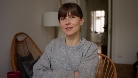 woman sitting at home, working or having breakfast