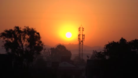 Revele-La-Toma-Del-Hermoso-Amanecer-Dorado-En-Cámara-Lenta,-La-Silueta-De-Un-Pájaro-Volando,-Mumbai,-India