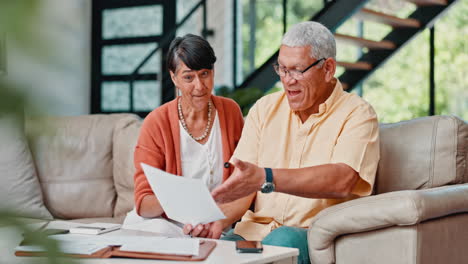 excited elderly couple reviewing documents