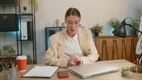 Businesswoman-enters-office-start-working-on-laptop-computer-at-desk-and-drinking-morning-coffee