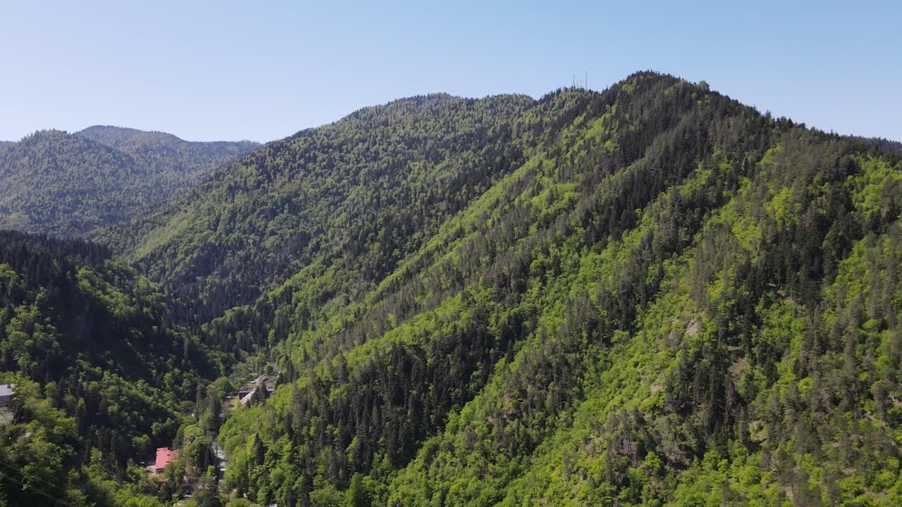 drone shot of beautiful green mountains sun clear sky