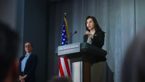 US-presidential-candidate-comes-to-tribune,-starts-performance,-answers-journalists-questions-and-gives-interview.-Female-American-republican-politician-at-press-conference.-Elections-day.-Dolly-shot.